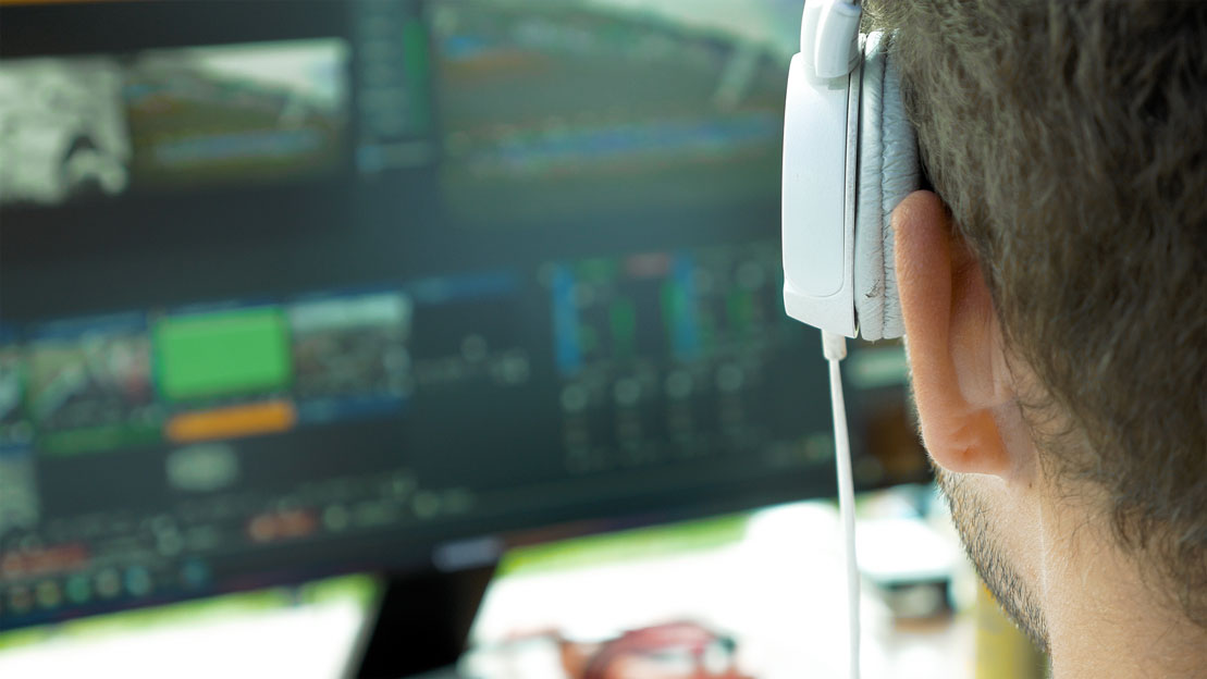 Video production professional reviewing footage